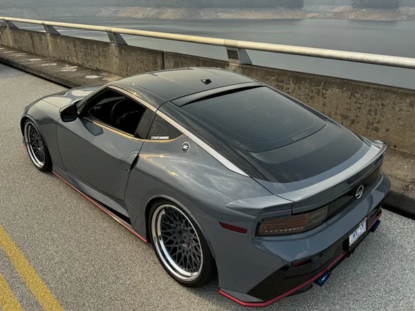 Gray Nissan Z Nismo on Fontana Dam, rear three-quarter view